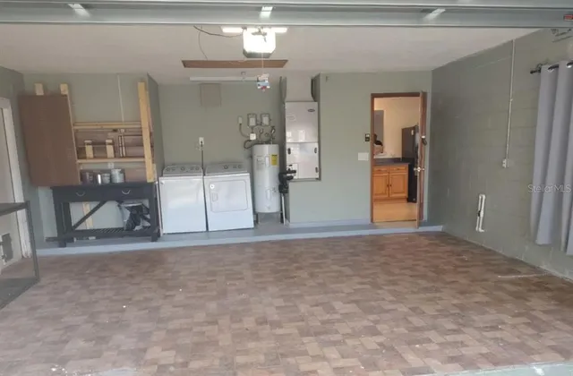 a view of white house with a yard and garage