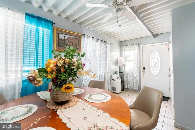 a view of a dining room with furniture and a potted plant