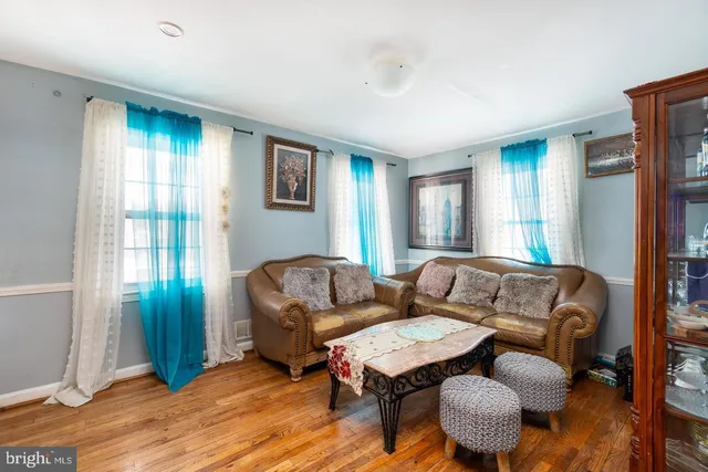 a living room with furniture a wooden floor and a window