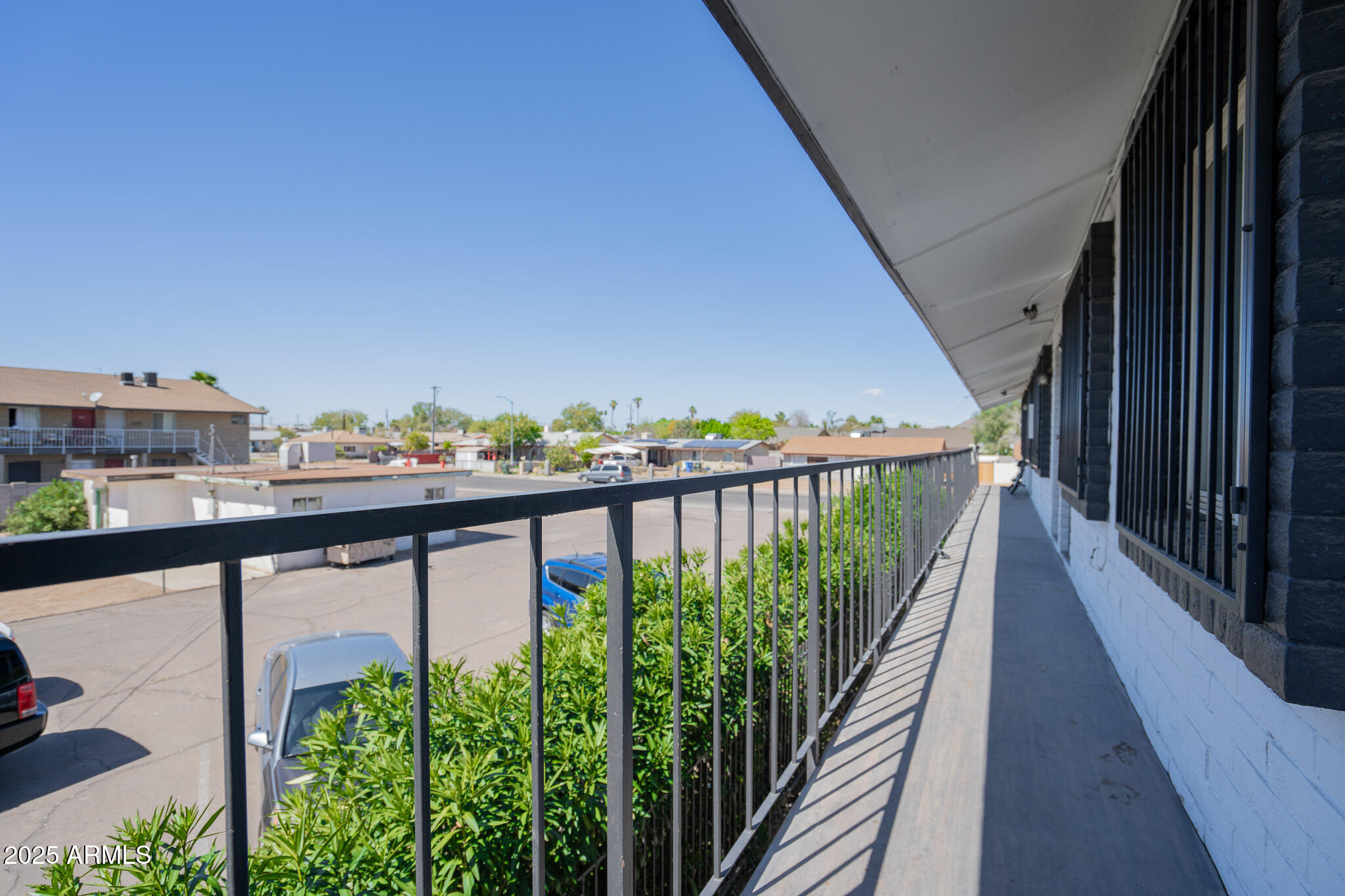 1703 West Mountain View Road, Unit 15 Phoenix, AZ 85021 - Photo 3 of 11 a view of a balcony with wooden floor and fence