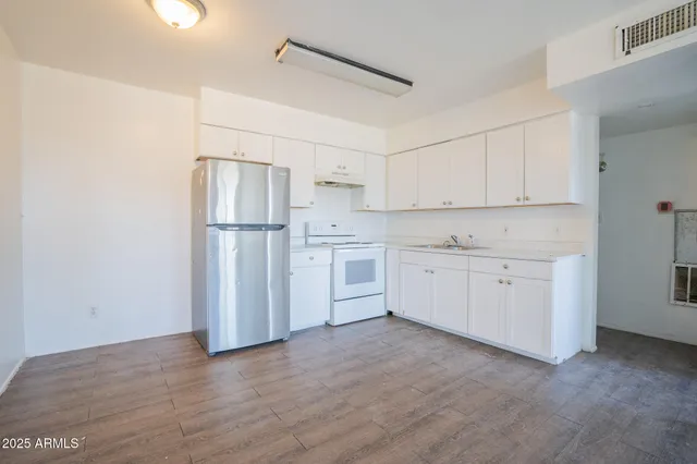 a view of a kitchen with an empty space and a window