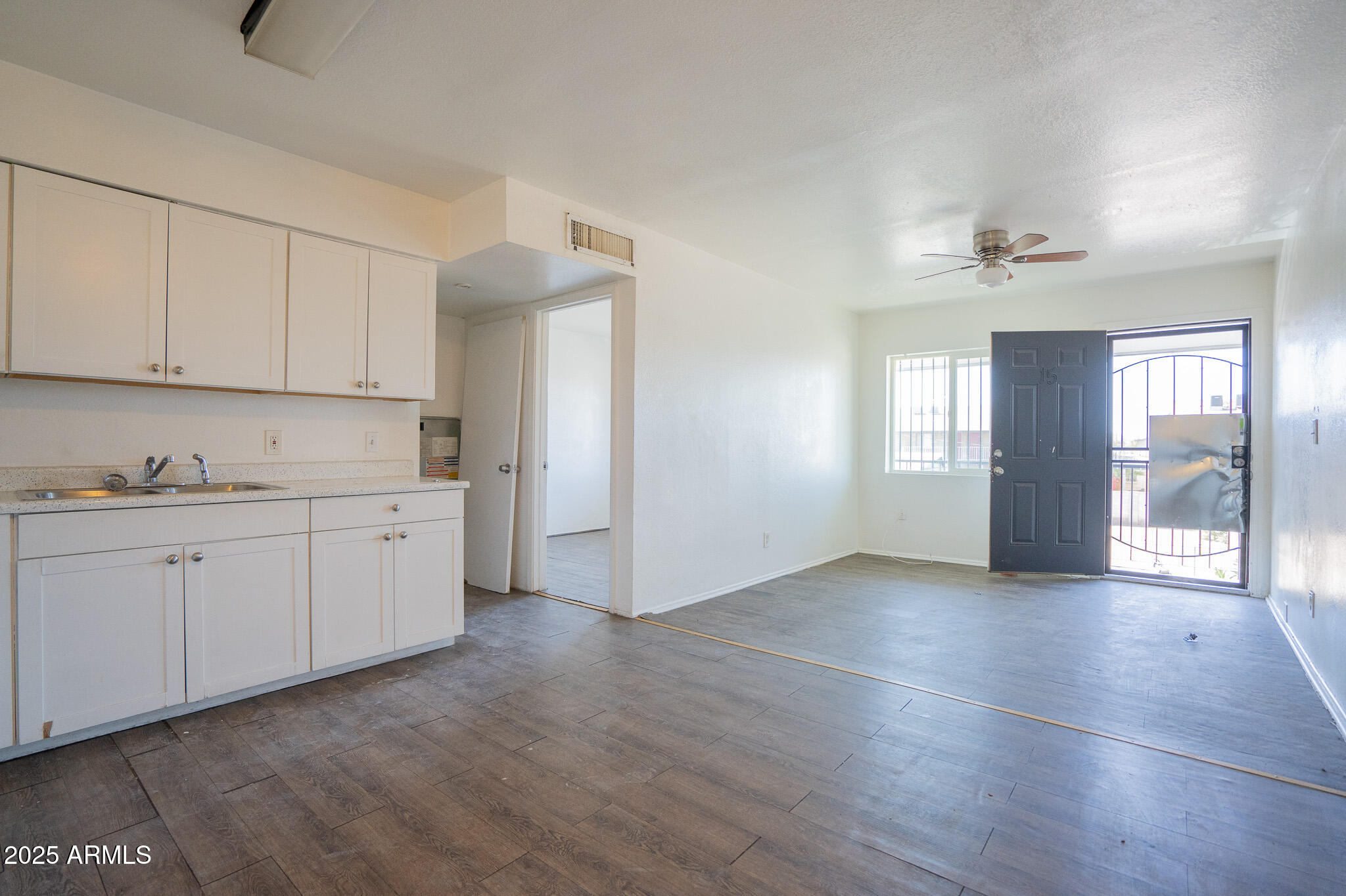 1703 West Mountain View Road, Unit 15 Phoenix, AZ 85021 - Photo 8 of 11 a view of a kitchen with an empty space and a window