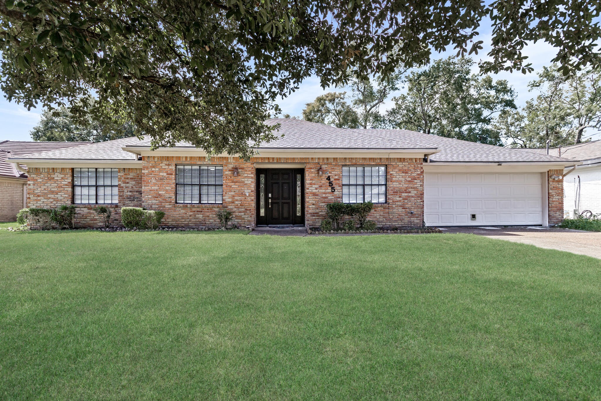 4455 Arthur Street Beaumont, TX 77706 - Photo 1 of 23 a front view of a house with a garden and yard