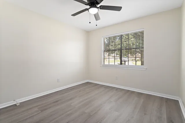 wooden floor in an empty room with a window