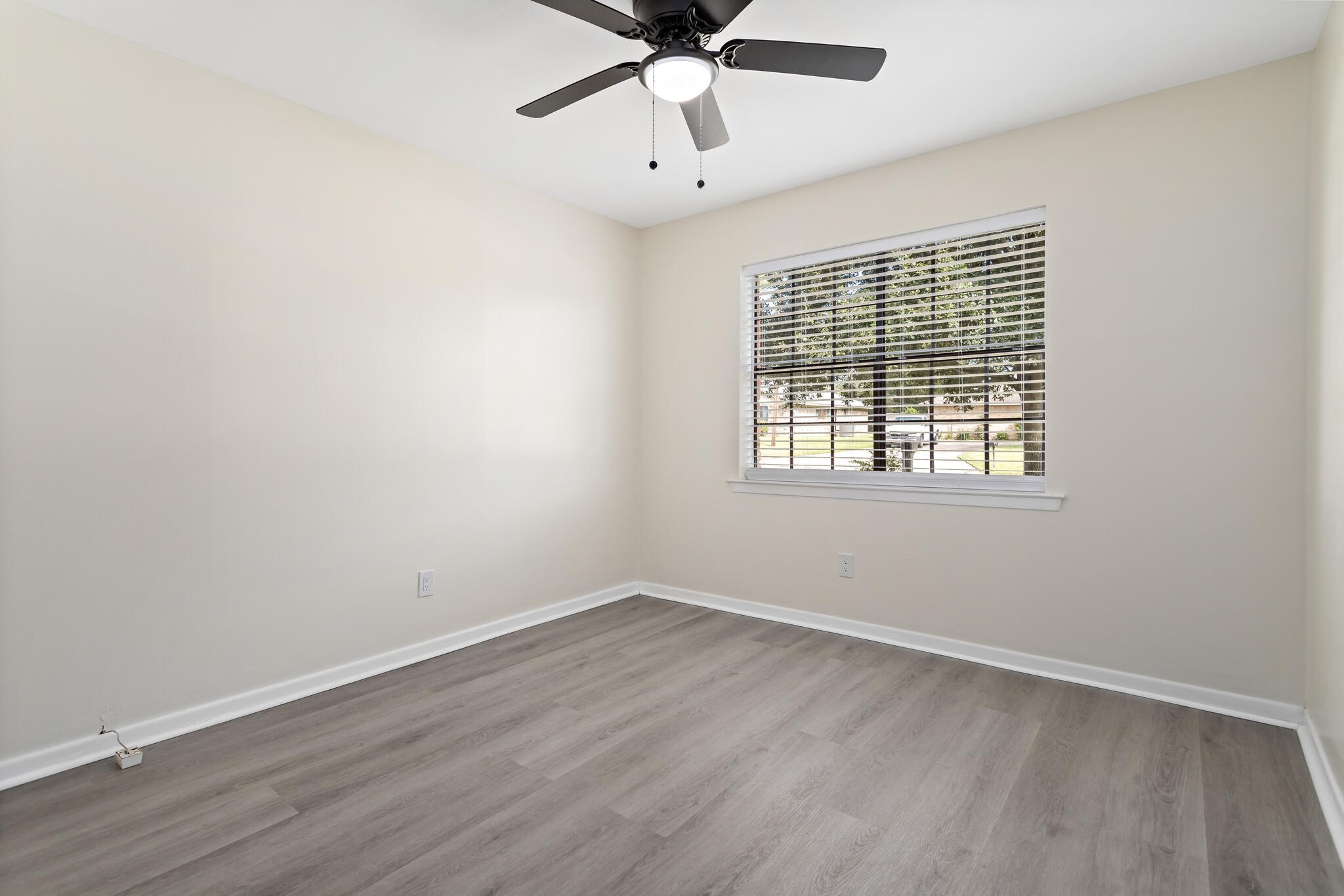 4455 Arthur Street Beaumont, TX 77706 - Photo 14 of 23 wooden floor in an empty room with a window