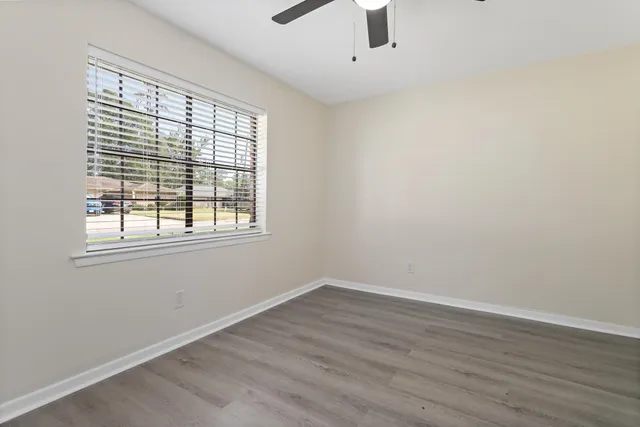 wooden floor in an empty room with a window