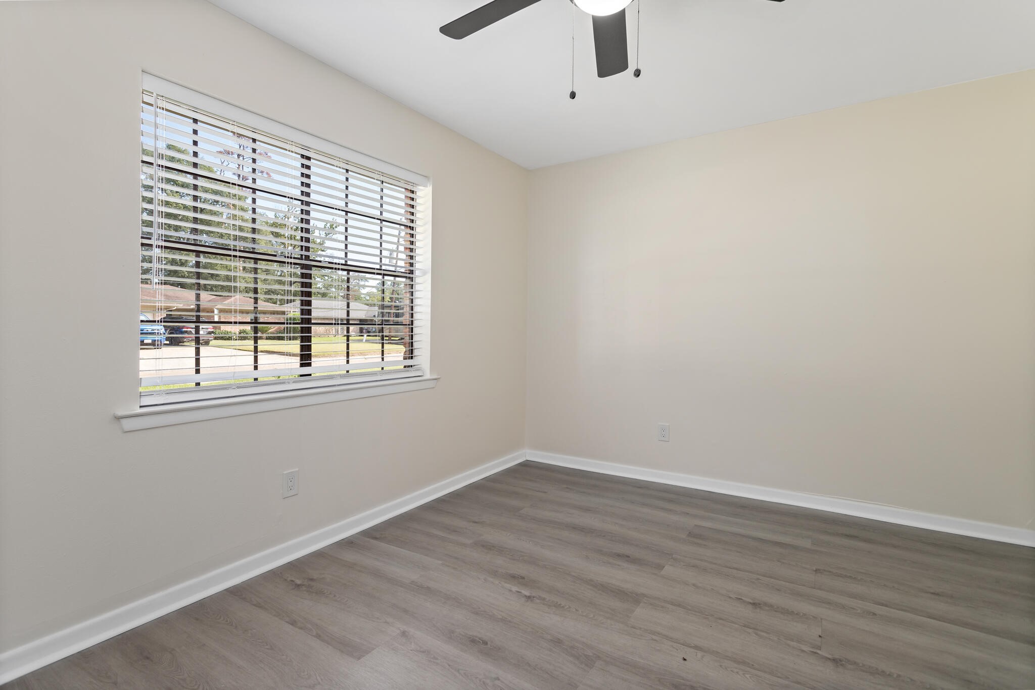 4455 Arthur Street Beaumont, TX 77706 - Photo 15 of 23 wooden floor in an empty room with a window