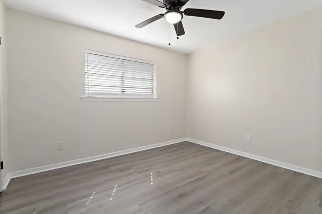 wooden floor in an empty room with a window