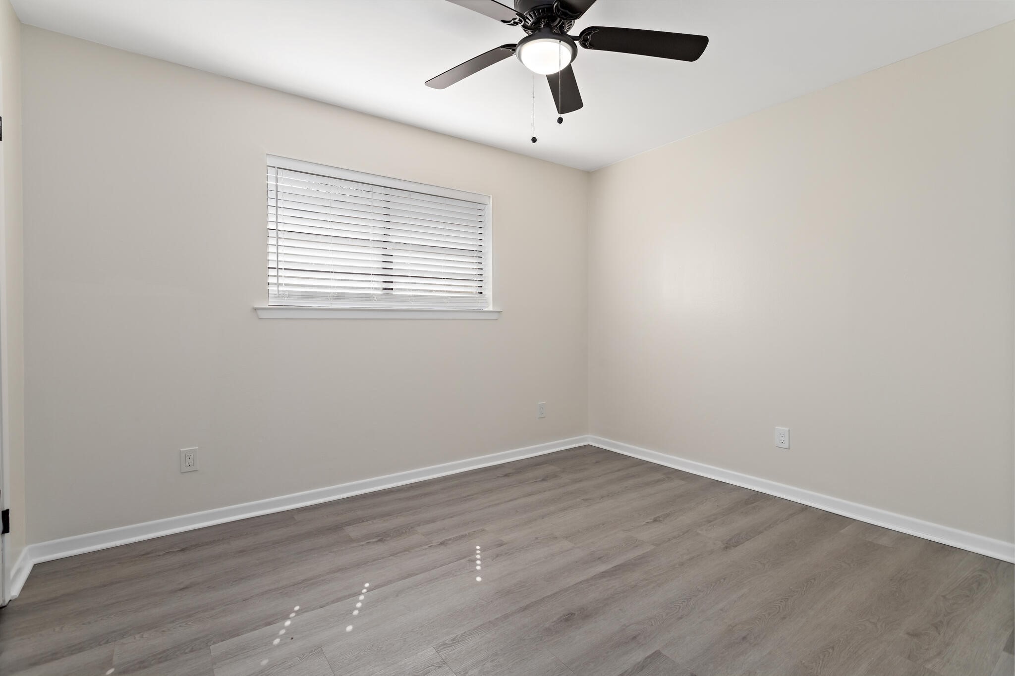 4455 Arthur Street Beaumont, TX 77706 - Photo 17 of 23 wooden floor in an empty room with a window