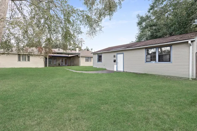 a view of a house with a backyard