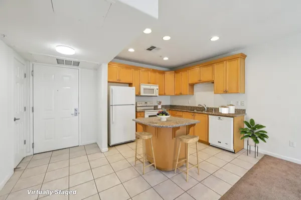 a kitchen with a sink appliances and cabinets