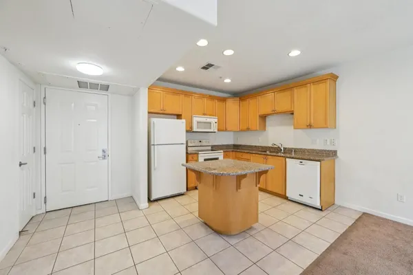 a kitchen with a refrigerator a sink and cabinets