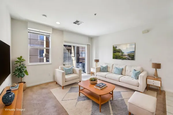 a living room with furniture potted plant and a window