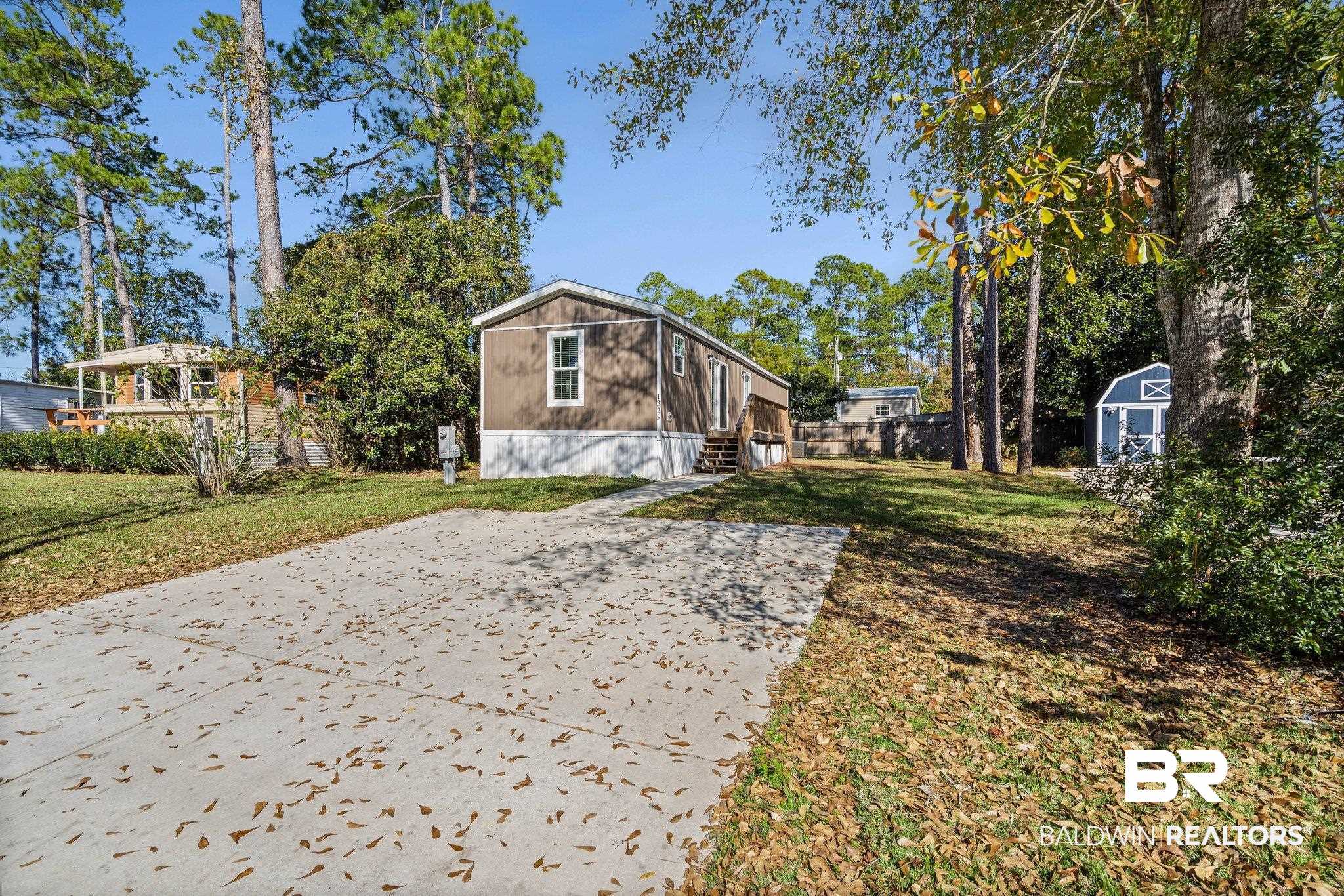 1325 Ridgewood Drive Lillian, AL 36549 - Photo 17 of 32 View of front of home with a front lawn and an outdoor structure