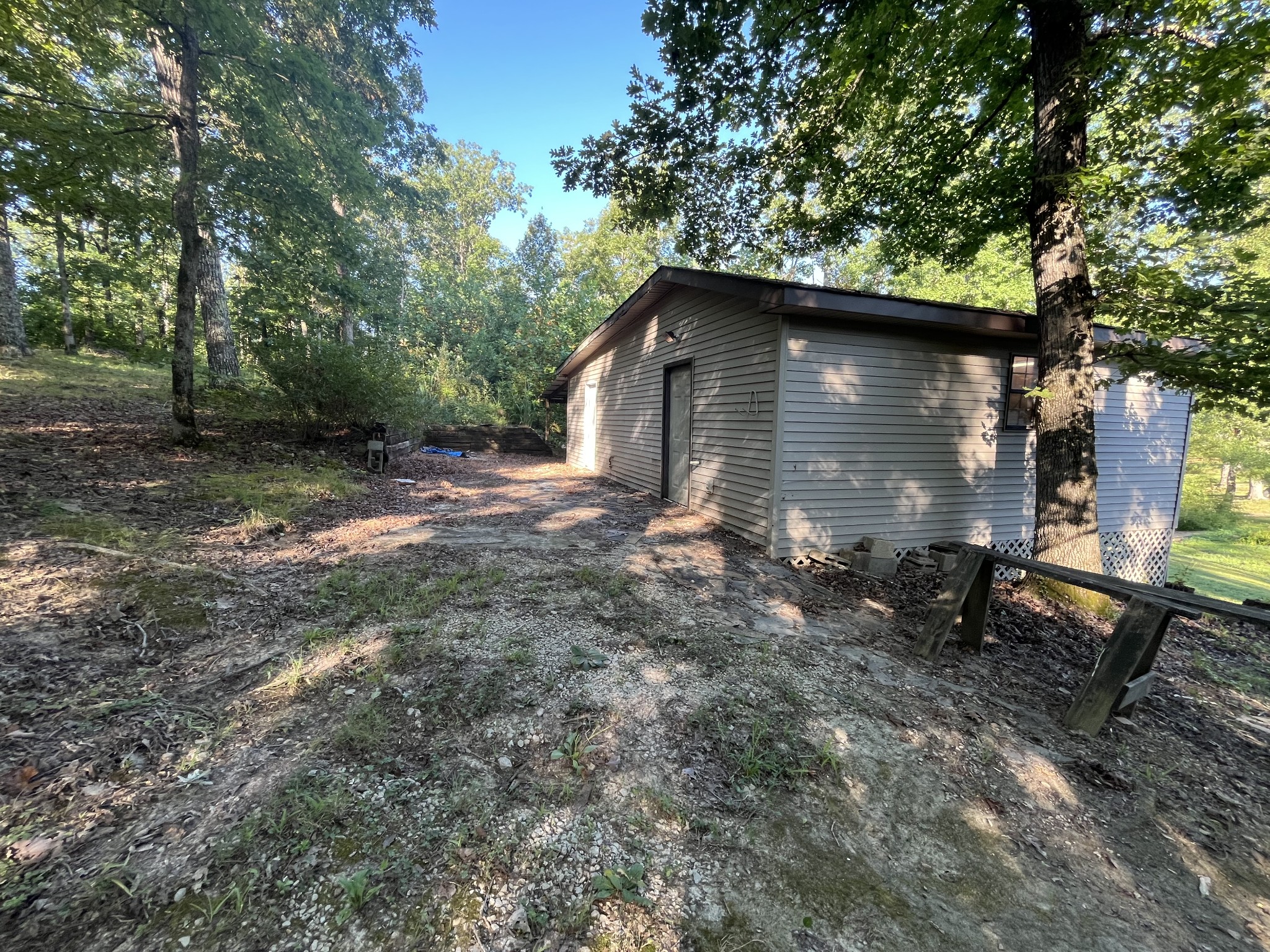 294 Ridgeway Drive Sugar Tree, TN 38380 - Photo 25 of 28 a backyard of a house with barbeque oven table and chairs