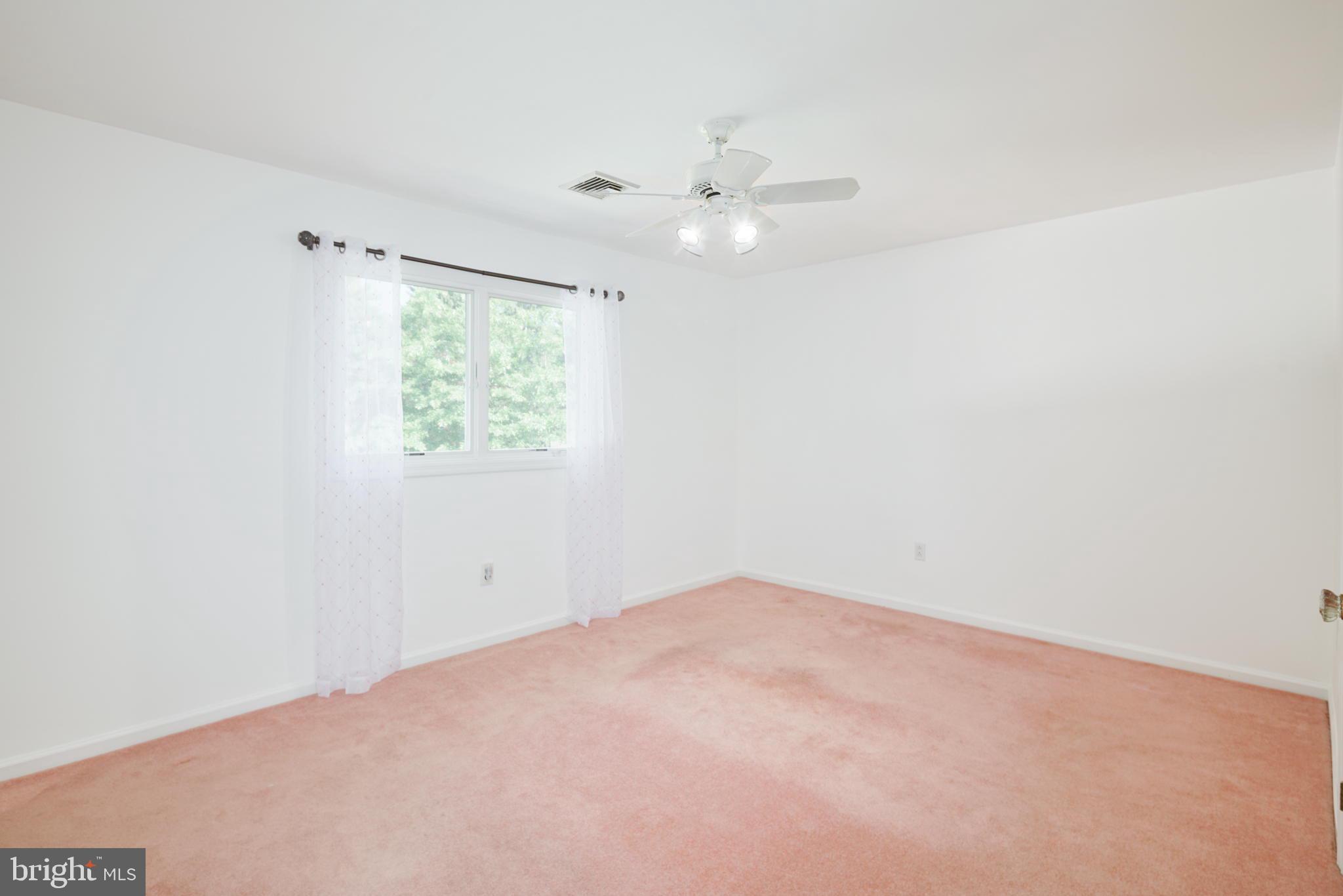 2041 Pennington Road Trenton, NJ 08618 - Photo 14 of 39 an empty room with a window and a fan