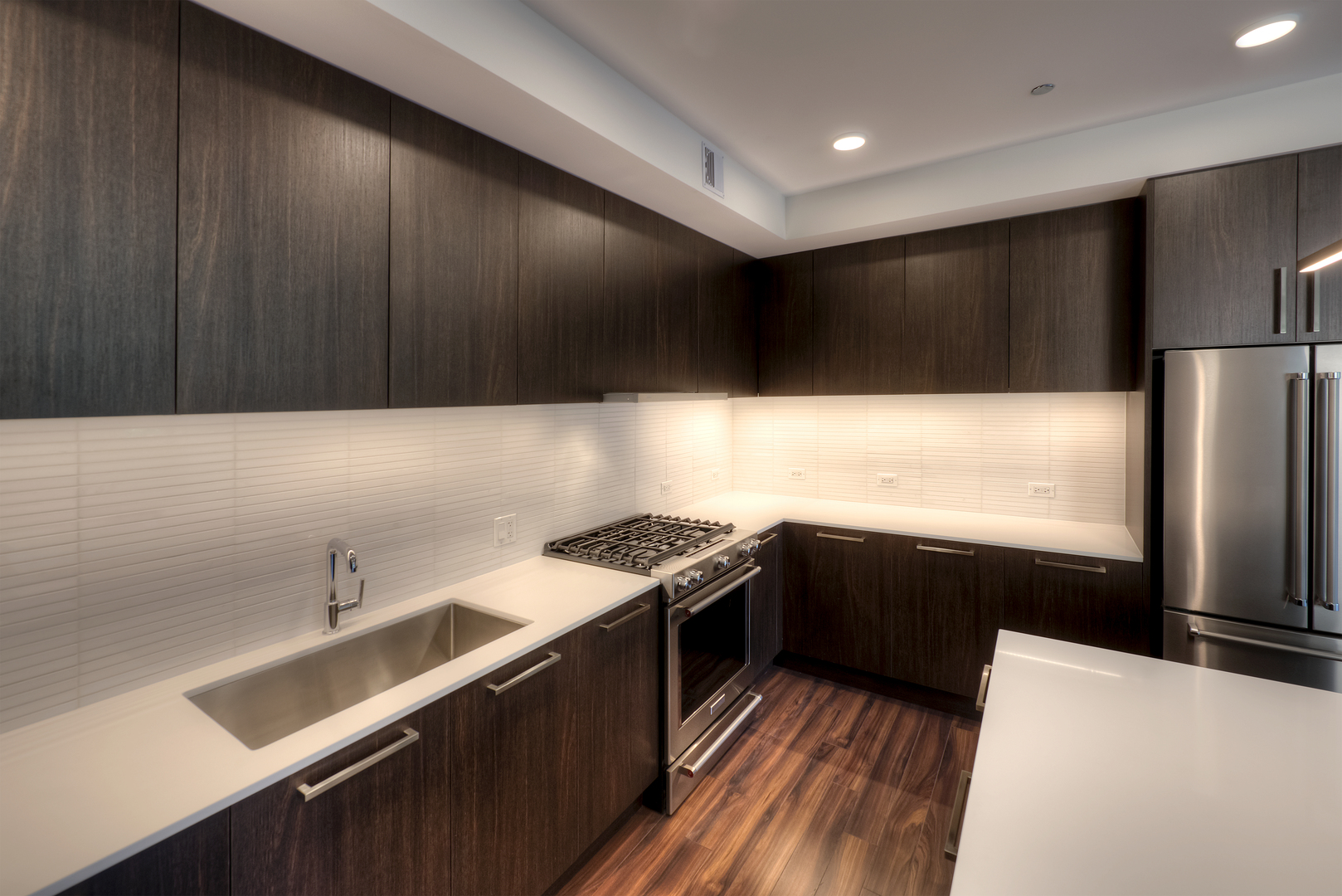 Undisclosed Address Chicago, IL 60657 - Photo 3 of 14 a kitchen with stainless steel appliances a sink a stove and a refrigerator