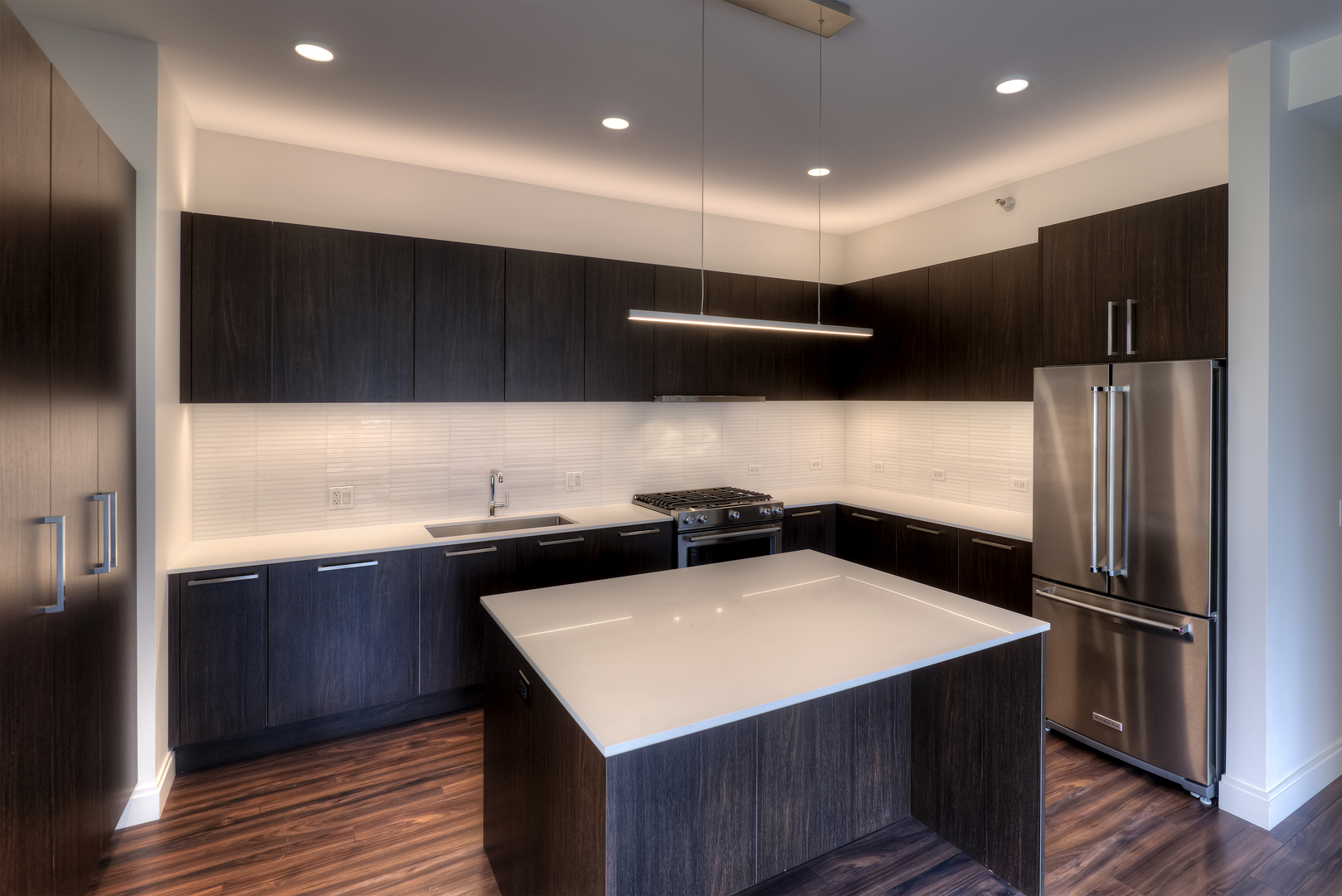 Undisclosed Address Chicago, IL 60657 - Photo 4 of 14 a kitchen with stainless steel appliances a refrigerator a sink a stove and cabinets