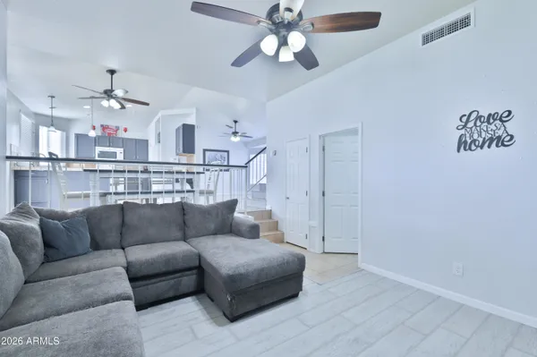a living room with furniture and a chandelier