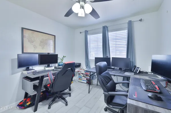 a view of a workspace with furniture and a window