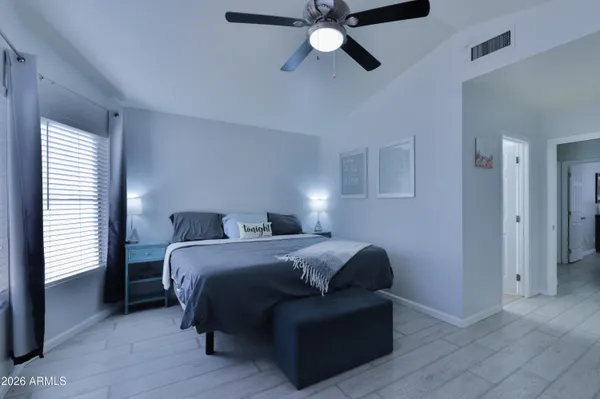 a bedroom with a bed and a large window