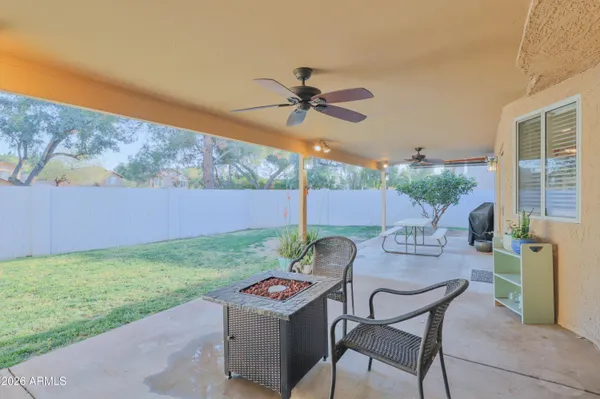 a view of a house with a yard and sitting area