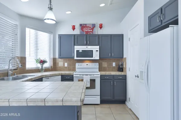 a kitchen with stainless steel appliances a stove a sink and a refrigerator