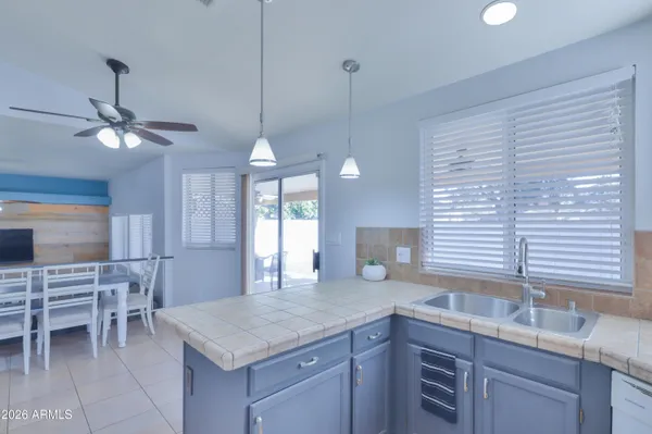 a kitchen with center island table and chairs