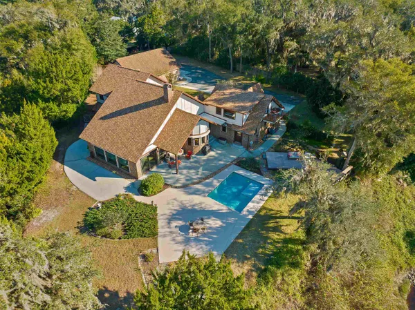 an aerial view of a house with yard swimming pool and outdoor seating