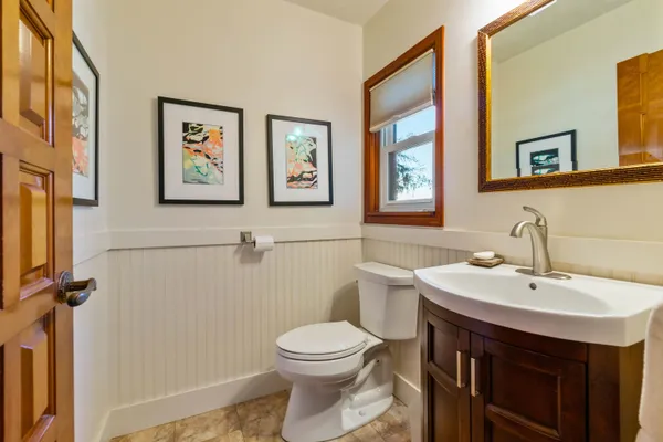 a bathroom with a sink a toilet and a mirror