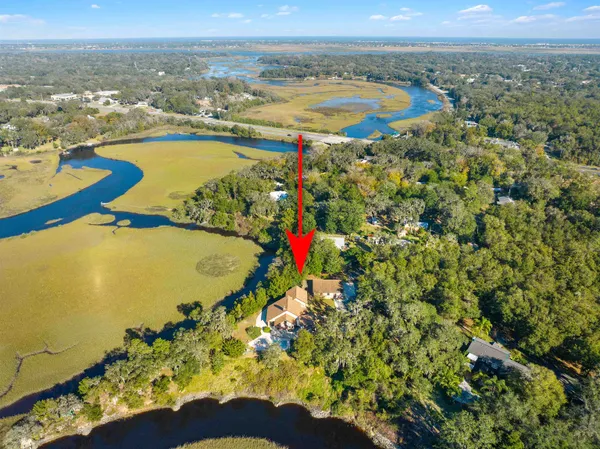 an aerial view of residential houses with outdoor space and swimming pool