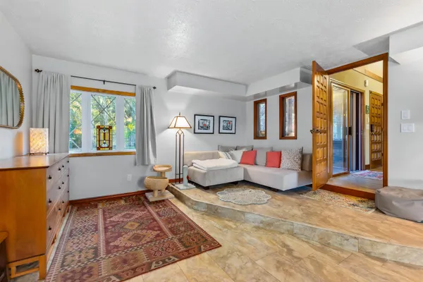 a bedroom with a bed and a chandelier