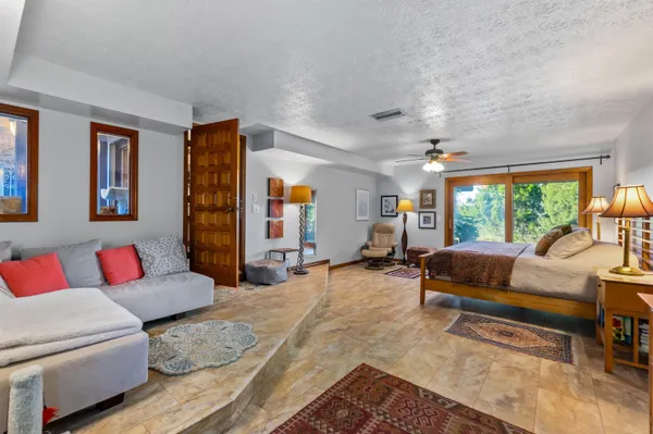 a living room with furniture and a floor to ceiling window
