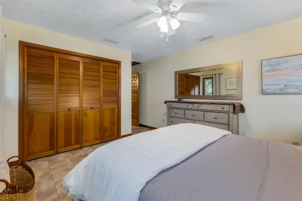 a view of a lake with couches and wooden fence