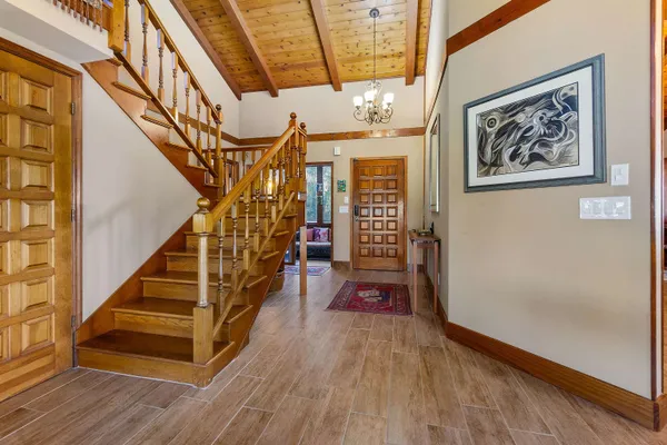 a view of entryway and hall with wooden floor