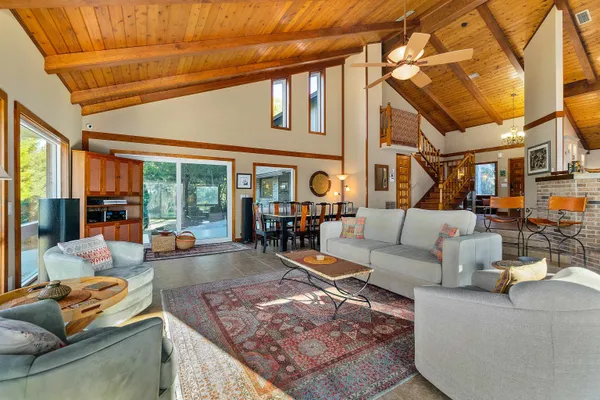 a living room with furniture a fireplace and a large window