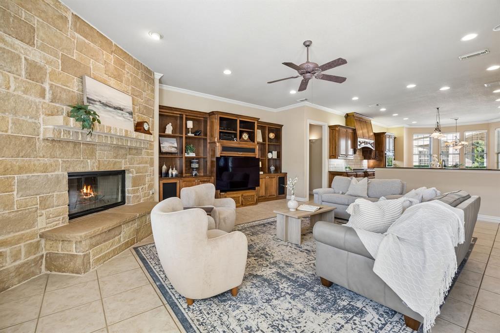 1135 Copper Canyon Road Copper Canyon, TX 76226 - Photo 22 of 40 Light-Filled Living Room Featuring Stone Fireplace And Built-Ins