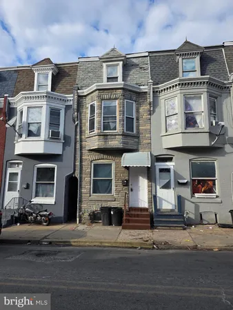 a front view of a residential apartment building with a yard