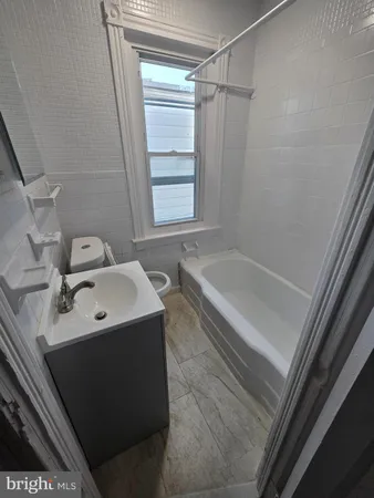 a bathroom with a sink a mirror and a bathtub