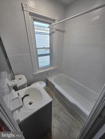 a bathroom with a tub and shower