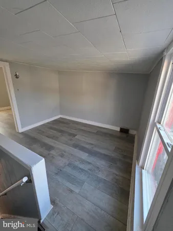 a view of an empty room and wooden floor
