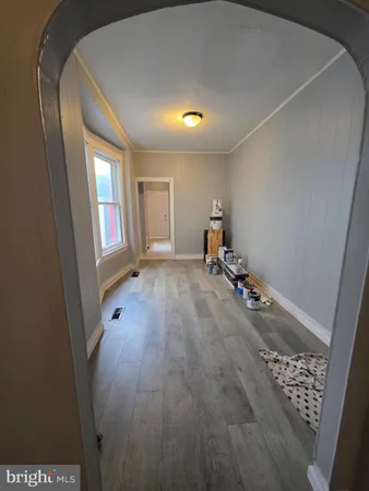 a view of a room with wooden floor and windows