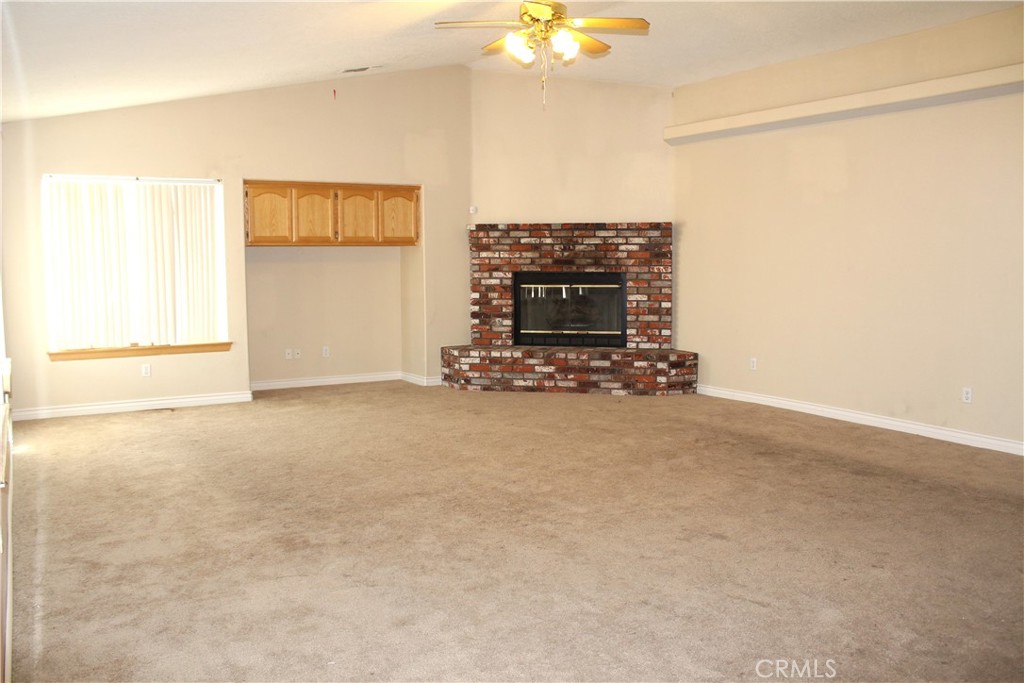 16263 Chiwi Road Apple Valley, CA 92307 - Photo 18 of 40 a view of empty room with fireplace