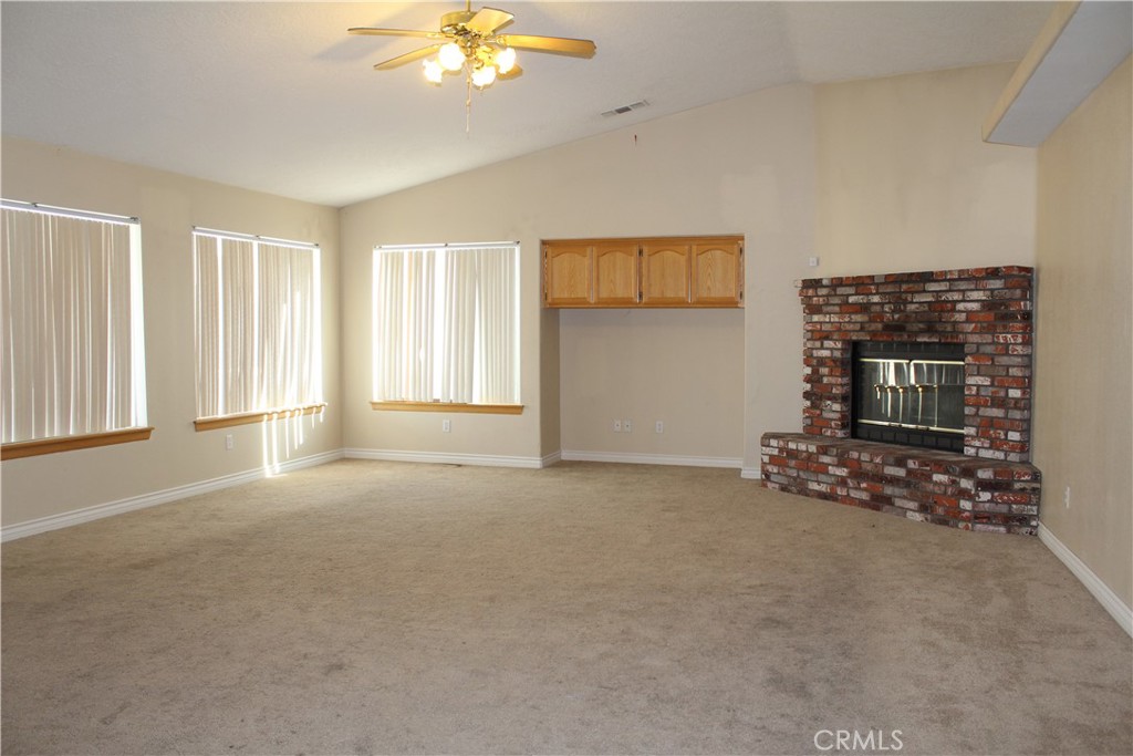 16263 Chiwi Road Apple Valley, CA 92307 - Photo 19 of 40 a view of an empty room with a fireplace