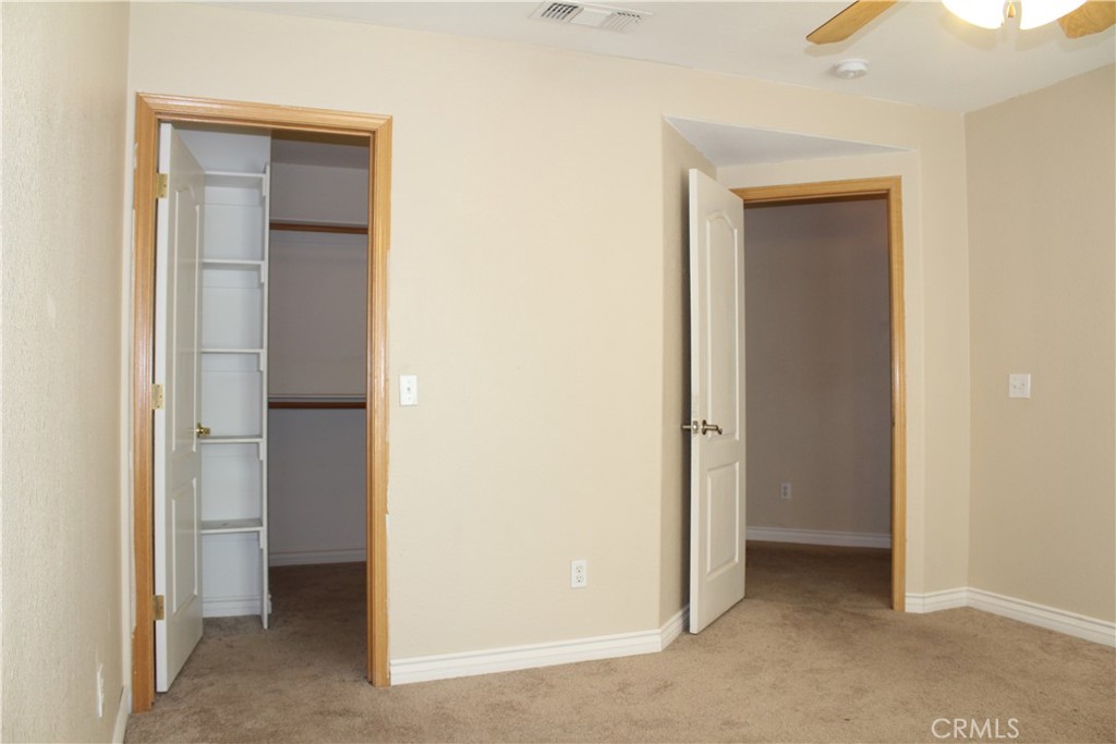 16263 Chiwi Road Apple Valley, CA 92307 - Photo 23 of 40 a view of an empty room with closet and wooden floor