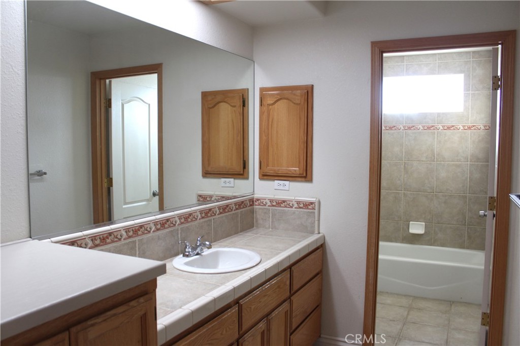 16263 Chiwi Road Apple Valley, CA 92307 - Photo 24 of 40 a bathroom with a sink and a mirror