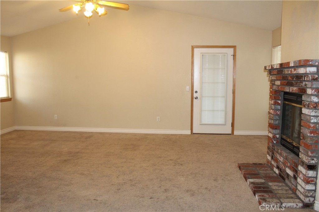16263 Chiwi Road Apple Valley, CA 92307 - Photo 32 of 40 a view of an empty room with a fireplace