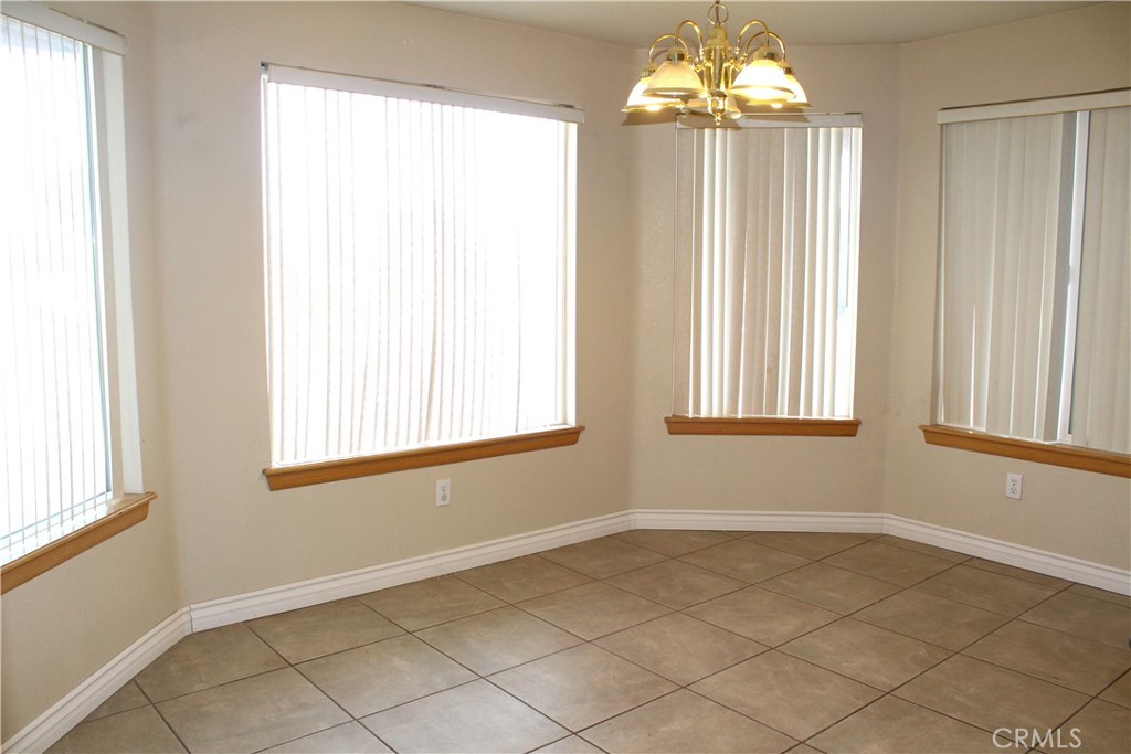 16263 Chiwi Road Apple Valley, CA 92307 - Photo 9 of 40 a view of an empty room with a window