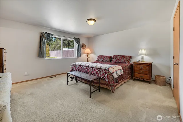 a bedroom with bed and a window