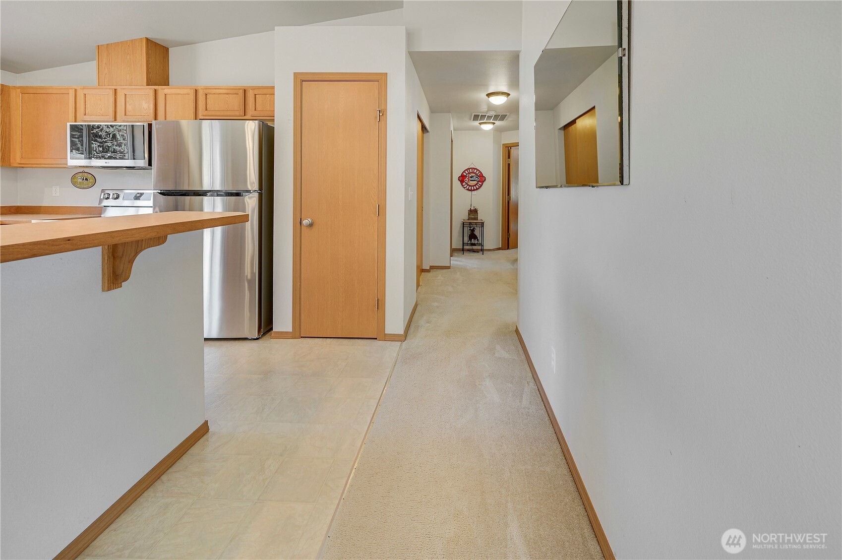 31 2nd Street Port Hadlock, WA 98339 - Photo 16 of 38 a hallway with stainless steel appliances a refrigerator and a cabinets